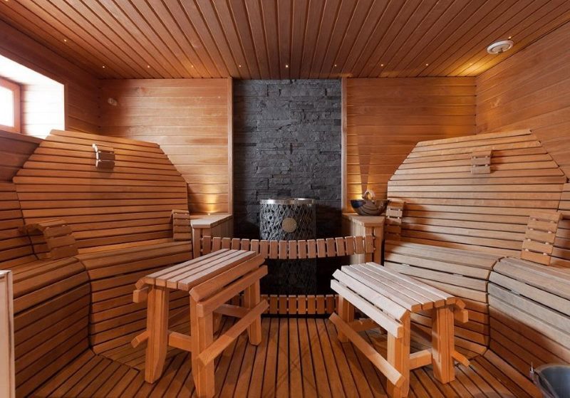 Comfortable armchairs made of slats in the interior of the steam room