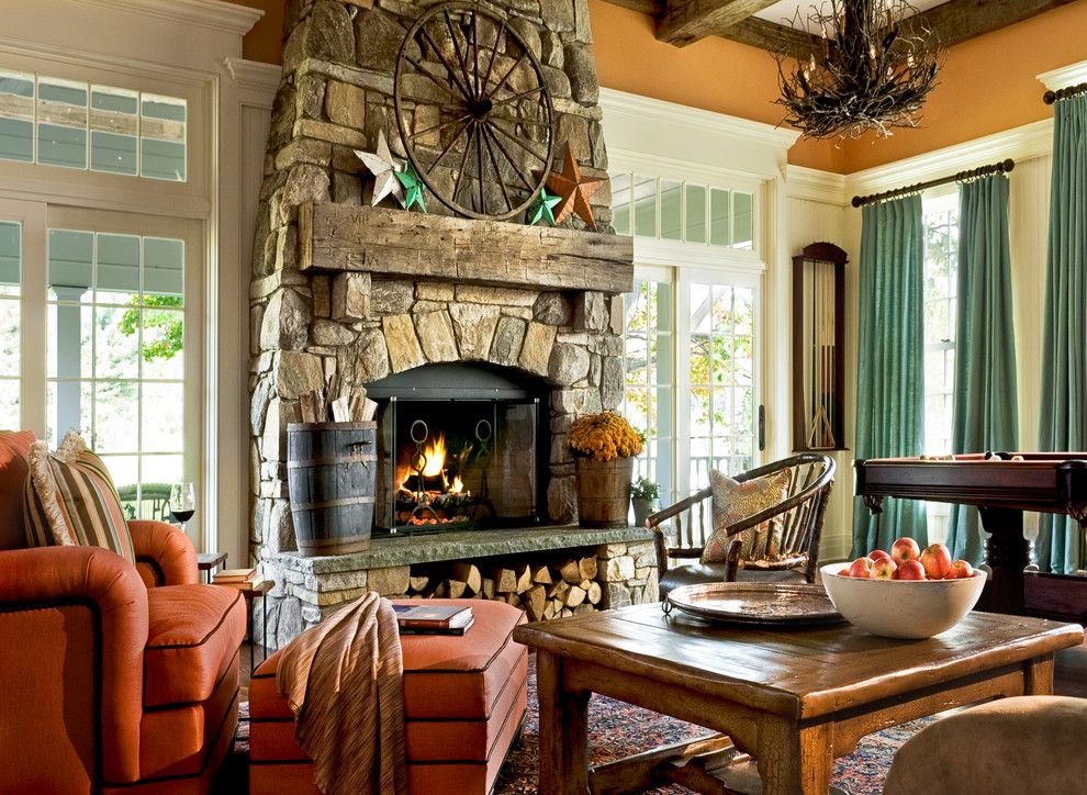 A comfortable chair in front of the fireplace in the living room of a private house