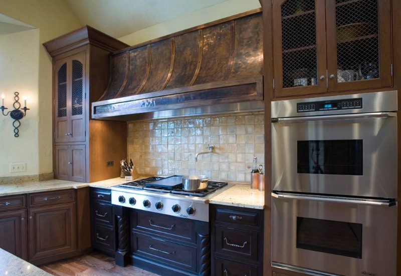 Copper hood in the kitchen with a wooden set