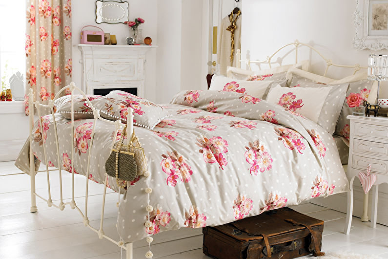 Textiles with pink print in the interior of a bright bedroom
