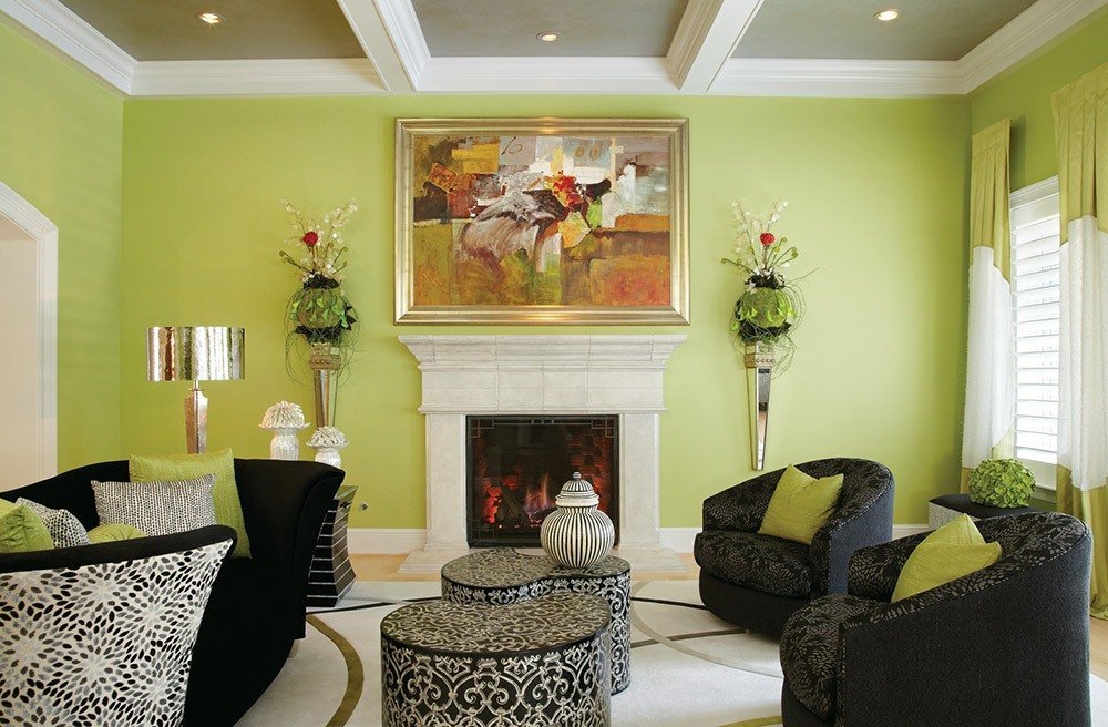 Black living room furniture with light green walls