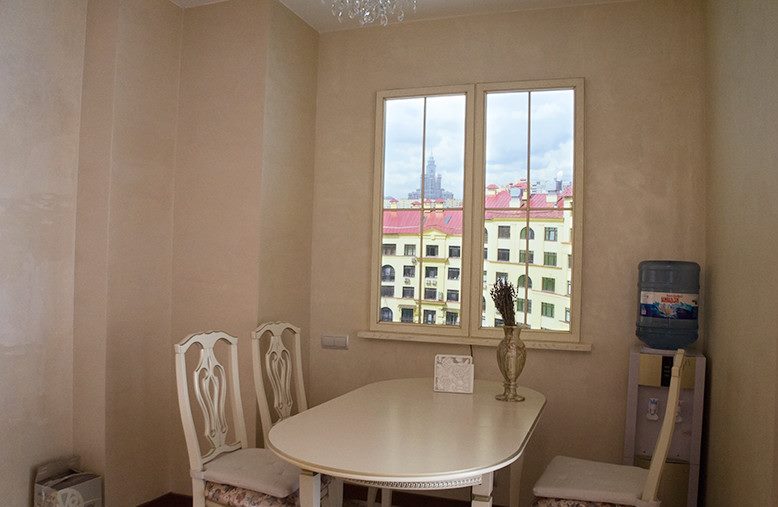 Dining area in front of a false window on the kitchen wall