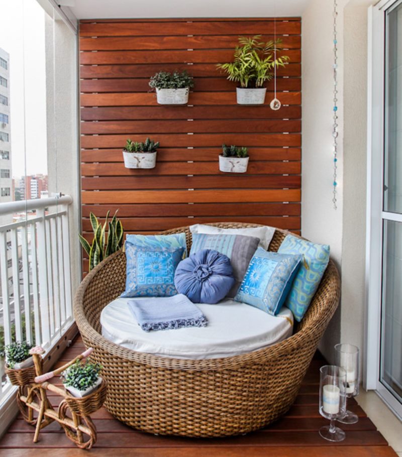 Sedia di vimini sul pavimento di legno di un balcone aperto