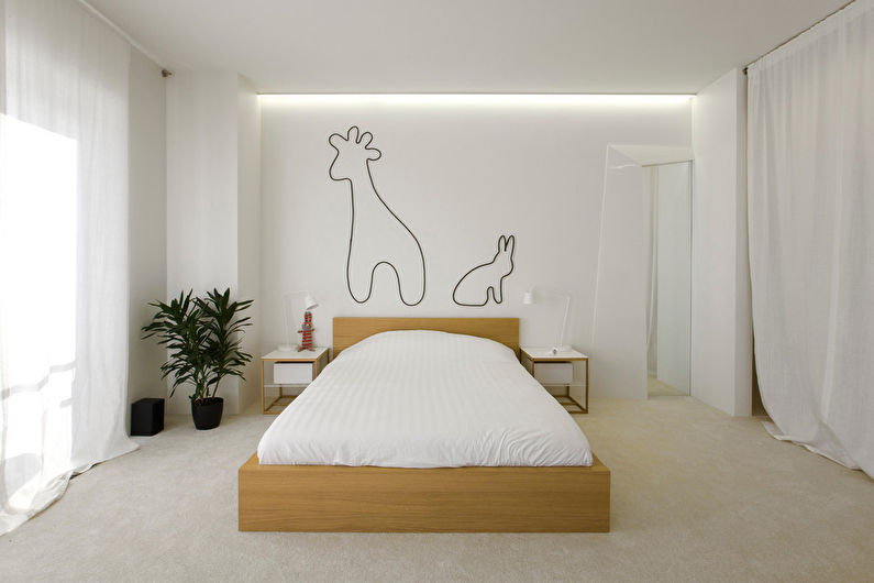 The contours of animals on the white wall of a modern bedroom