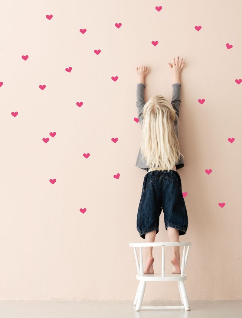 Decoration of a pink wall with red hearts