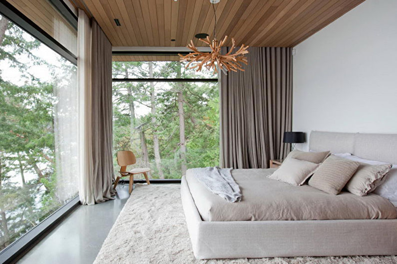 Gray curtains on the panoramic windows of the bedroom