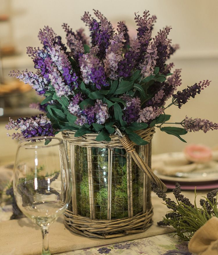 Artificial lilac flowers in a glass vase