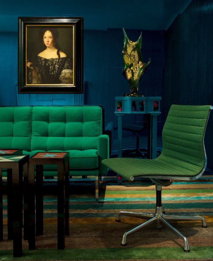 Green furniture against the dark blue walls of the living room