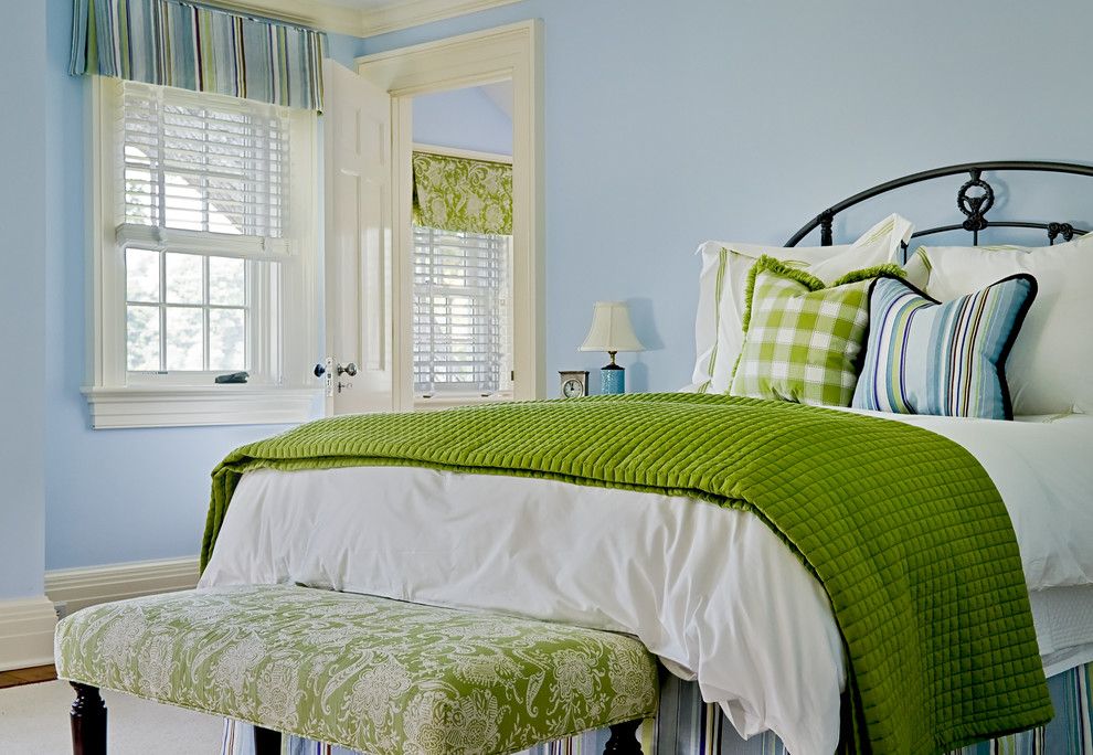 Green bedspread in a bedroom with blue walls