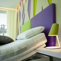 Violet color combined with green in the bedroom interior