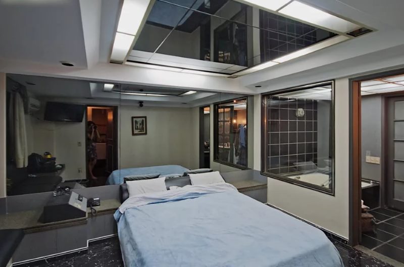 The bedroom of the young couple with a mirrored ceiling