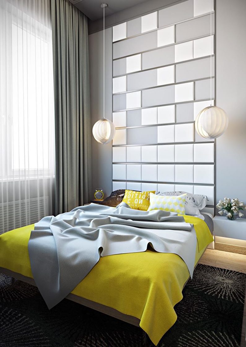 Chambre grise avec un couvre-lit jaune sur le lit