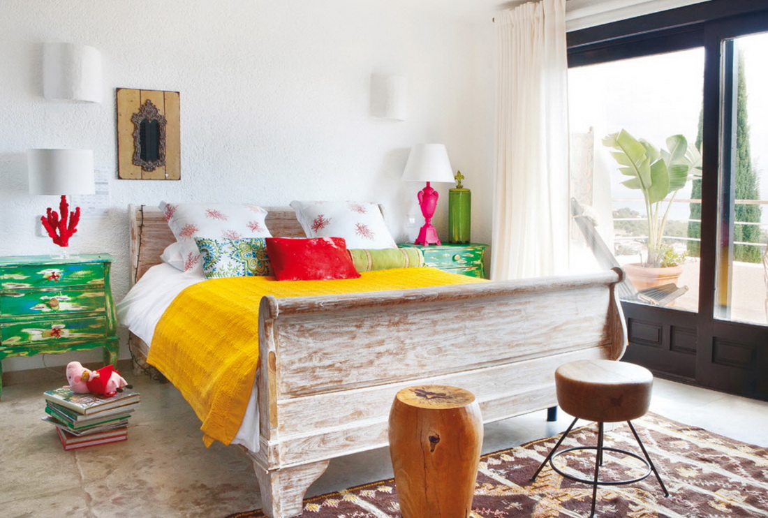 Yellow bedspread on a wooden bed