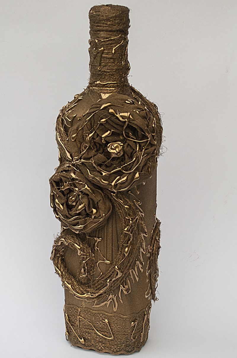 Golden bottle with pantyhose flowers