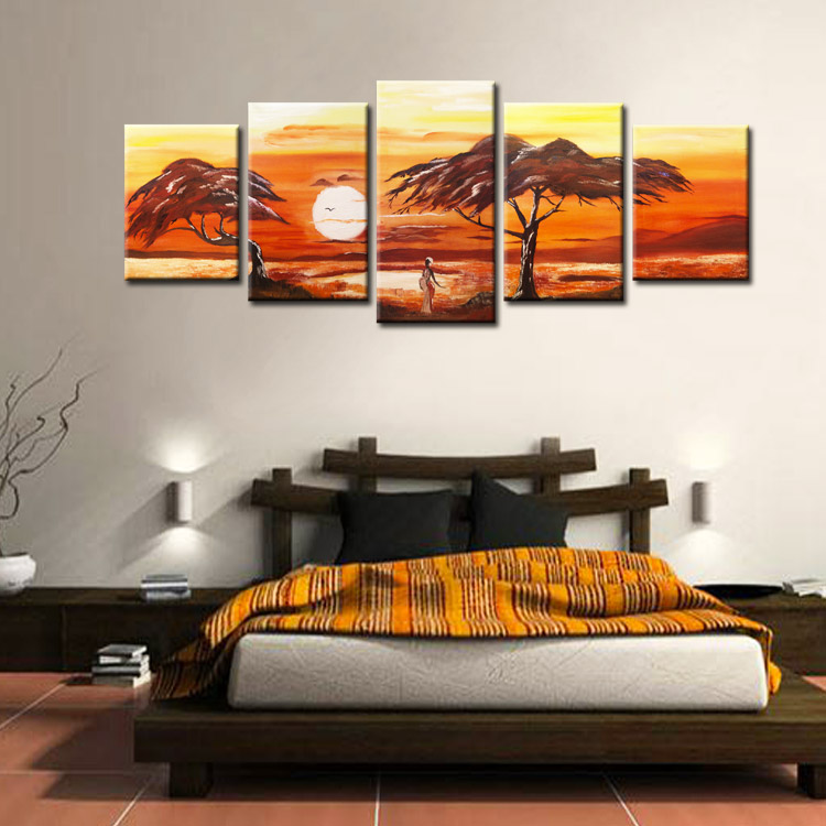 Low bed in the bedroom with paintings on the wall