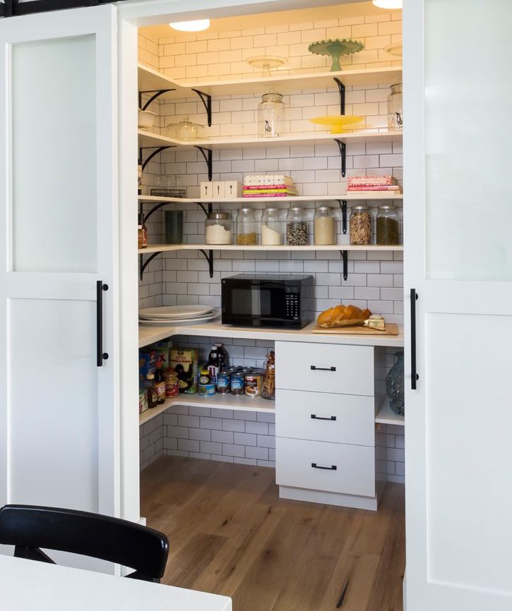 Open shelves in a pantry with white walls