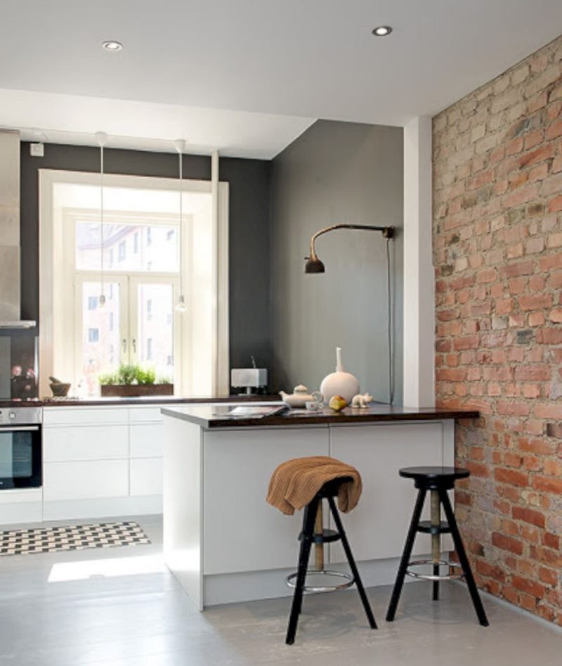 A combination of brickwork with a gray kitchen finish