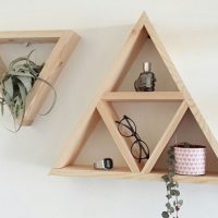 Triangular plank shelves on a white wall