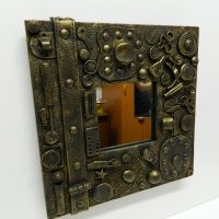A small mirror with a frame in the style of steampunk