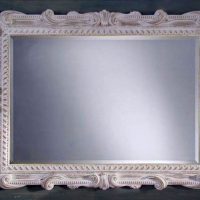 Stylish mirror in a wooden baguette