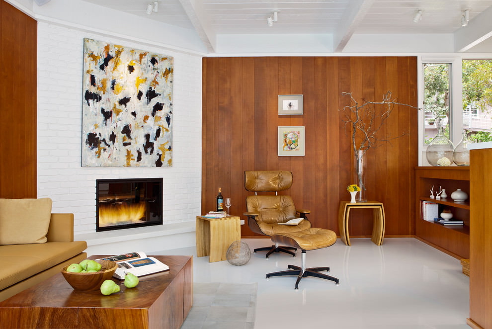 Living room interior with white floor and wooden wall trim.