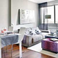Gray sofa in the lounge area of ​​the kitchen-living room