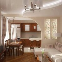 Design of a kitchen-living room with an arch