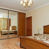 Sliding wardrobe with mirror doors in a bedroom interior