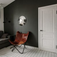 Wooden armchair in a room with dark gray walls