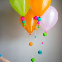 Helium balloons with paper pompons