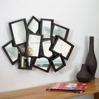 Panel of small mirrors in black frames