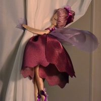 Fairy-tale doll on a cream-colored curtain