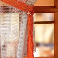 Orange yarn curtain garter