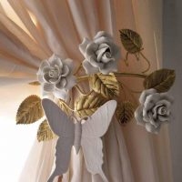 Butterfly made of plastic on a beige curtain