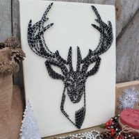 Deer head made of black thread and carnations
