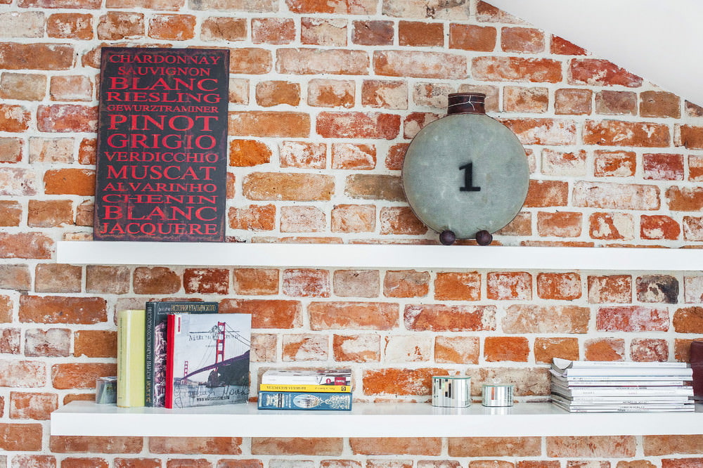 Shelves with decorations on a brick wall