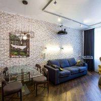 Salon avec mur de briques dans l'appartement d'un immeuble de plusieurs étages