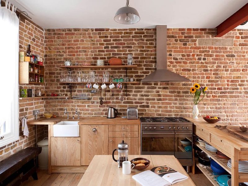 Wooden kitchen furniture with brick wall