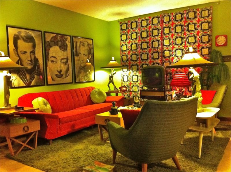 Red sofa and portraits in the living room kitsch style lumpens