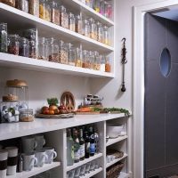 Open shelves from boards in the kitchen pantry