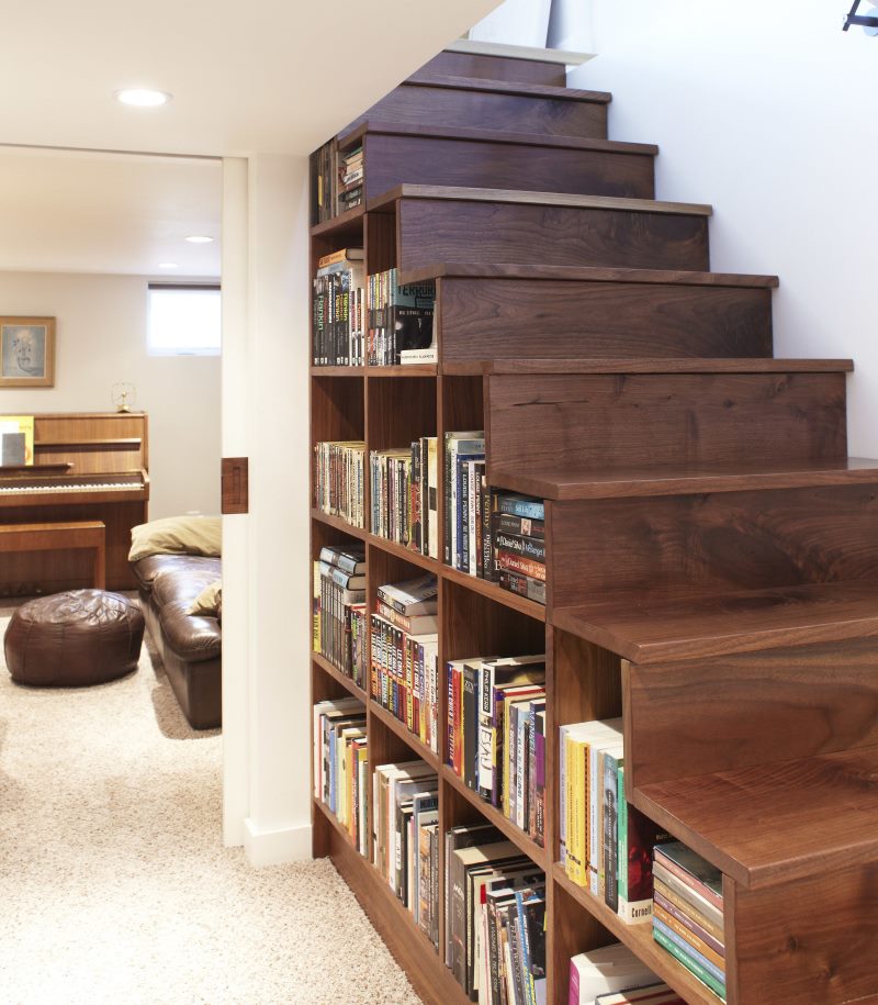 Bookshelves under the stairs to the second floor of a private house