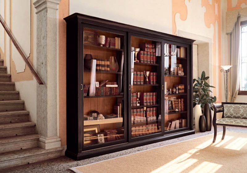 Storage of books in a sliding wardrobe with glass doors