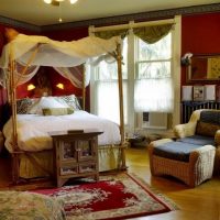 Four-poster bed in a burgundy bedroom
