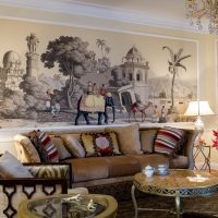 Wall mural with indian motifs over the sofa in the living room
