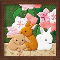 Picture in a wooden frame with fabric animals