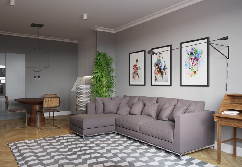 Modular paintings over a gray sofa