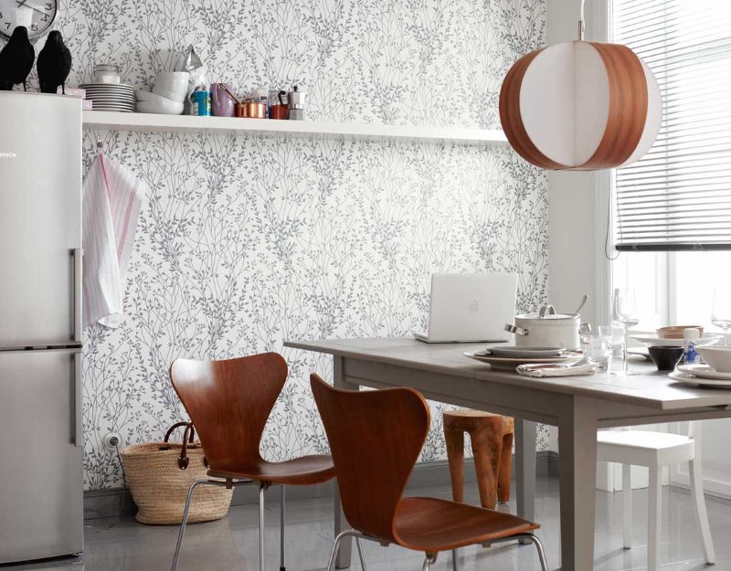 Gray dining table in the kitchen with paper wallpaper