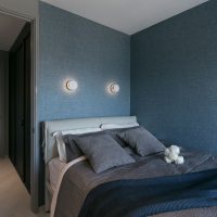 Blue textile wallpaper on bedroom walls