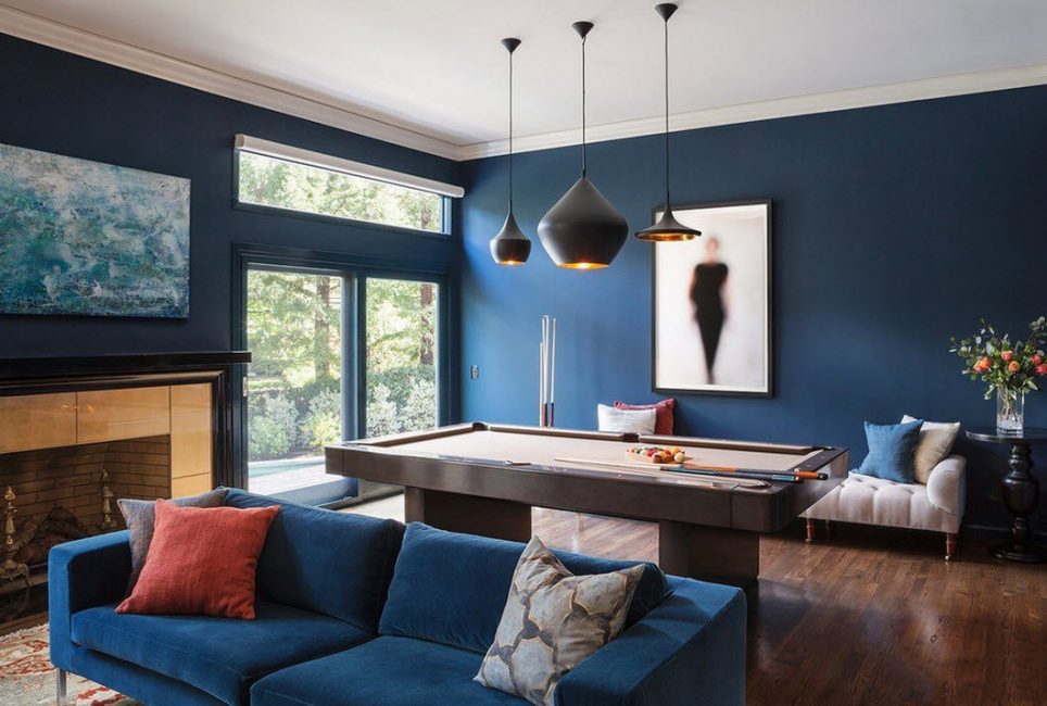 Billiard table in a room with blue walls.