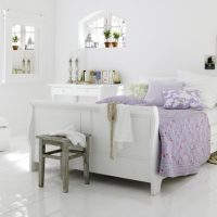 Lilac bedspread on a white bed